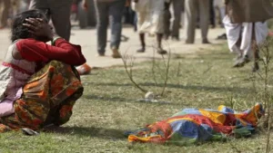 A woman cries next to the body of a victim killed in the stampede at Ratangarh temple which killed 115 people on October 13, 2013.