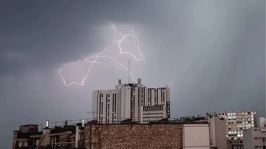 A lightning bolt is seen over the roofs of buildings during a thunderstorm in Paris A lightning bolt is seen over the roofs of buildings during a thunderstorm in Paris